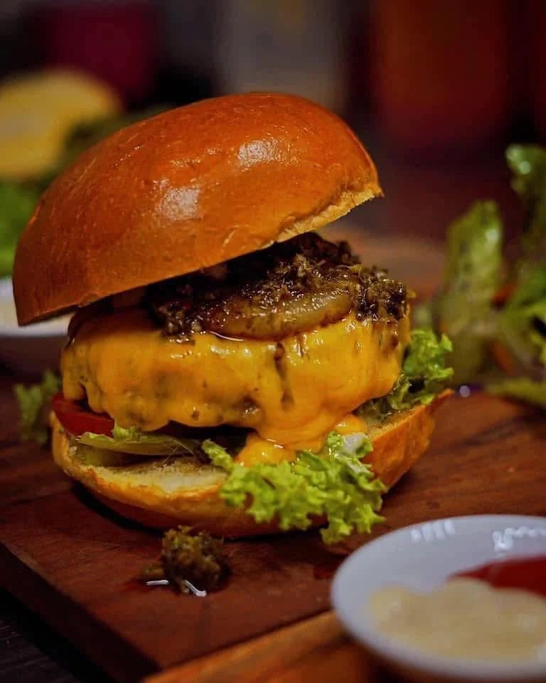 Cheeseburger with melted cheese and relish on a brioche bun