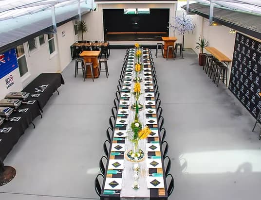Long dining table with buffet station at a Three Furlongs function