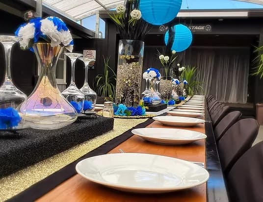 Formal function table setting with blue and gold décor at Three Furlongs