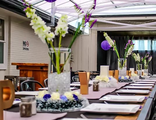 Function table with purple and lilac floral décor at Three Furlongs