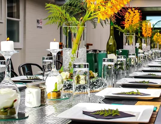 Function table with silver runner and ginger lily centrepieces